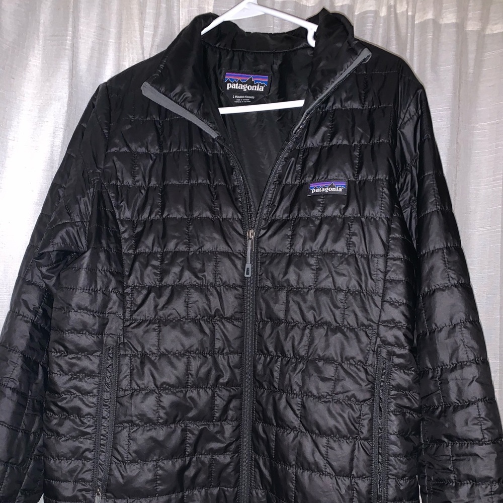 Women’s large Patagonia zip up black nano puff jacket.